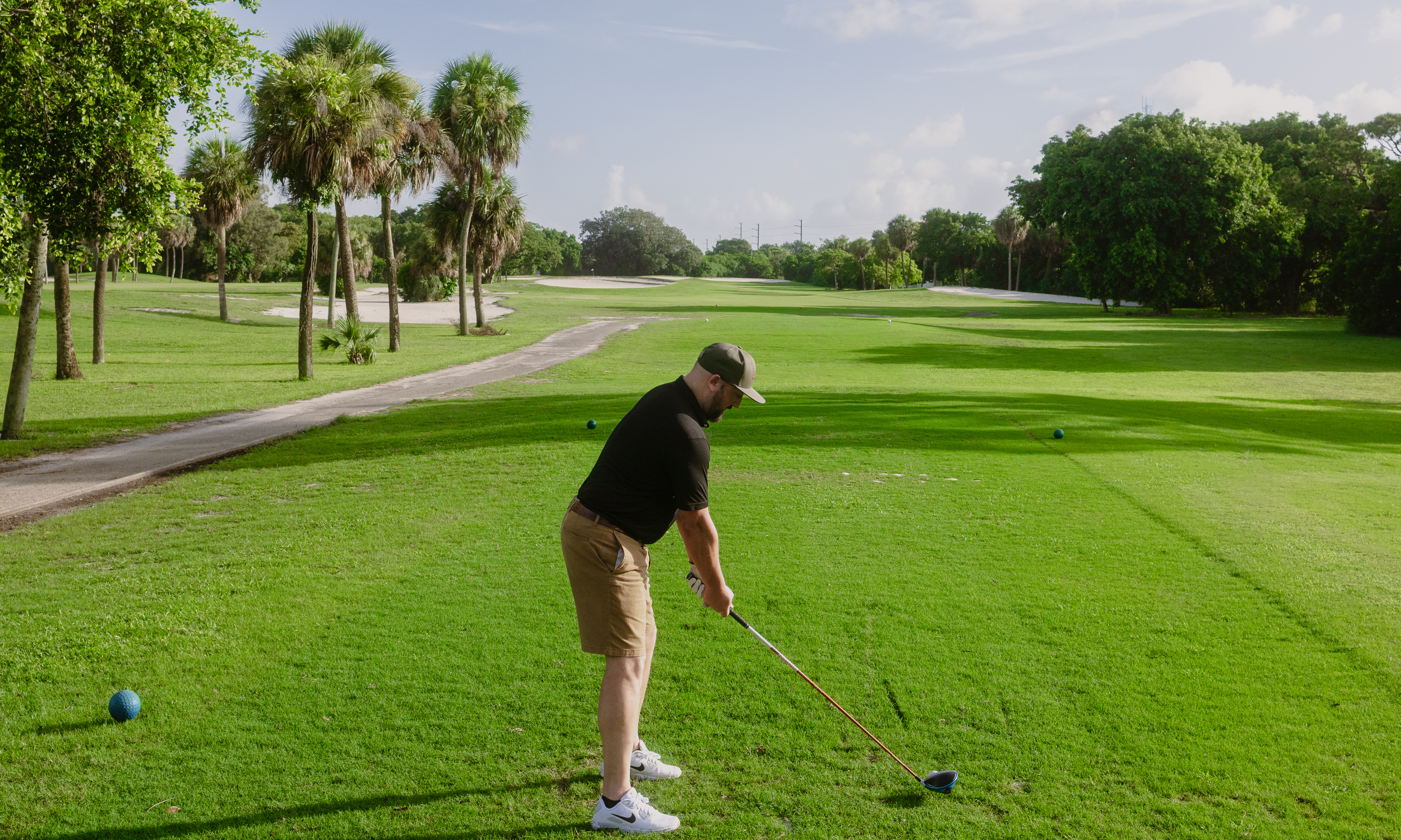 Golfer addressing ball on number 1 tee box