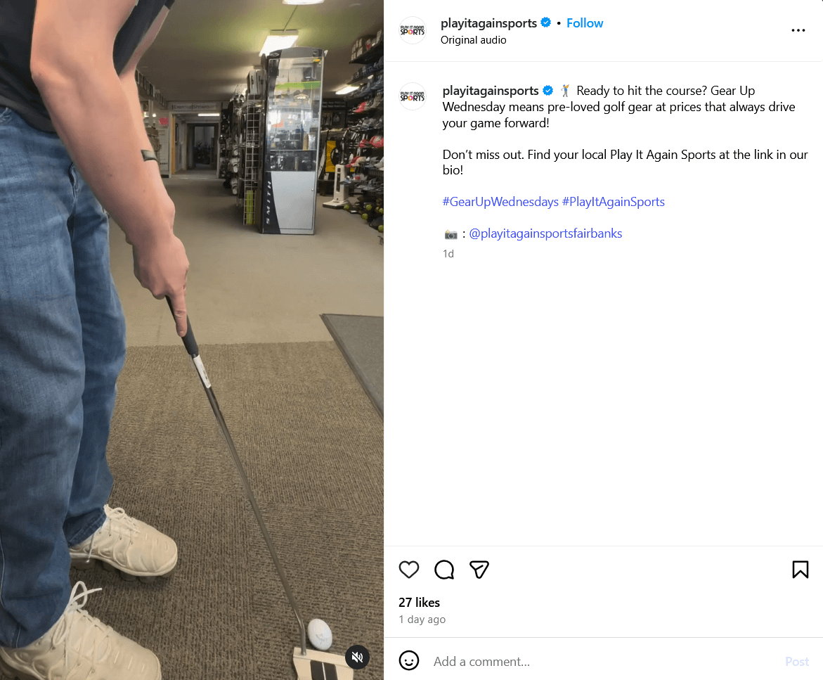 a person practicing a putting swing inside of a Play It Again Sports' store