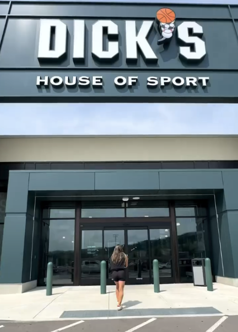 woman walking into Dick's Sporting Goods Store in New Orleans