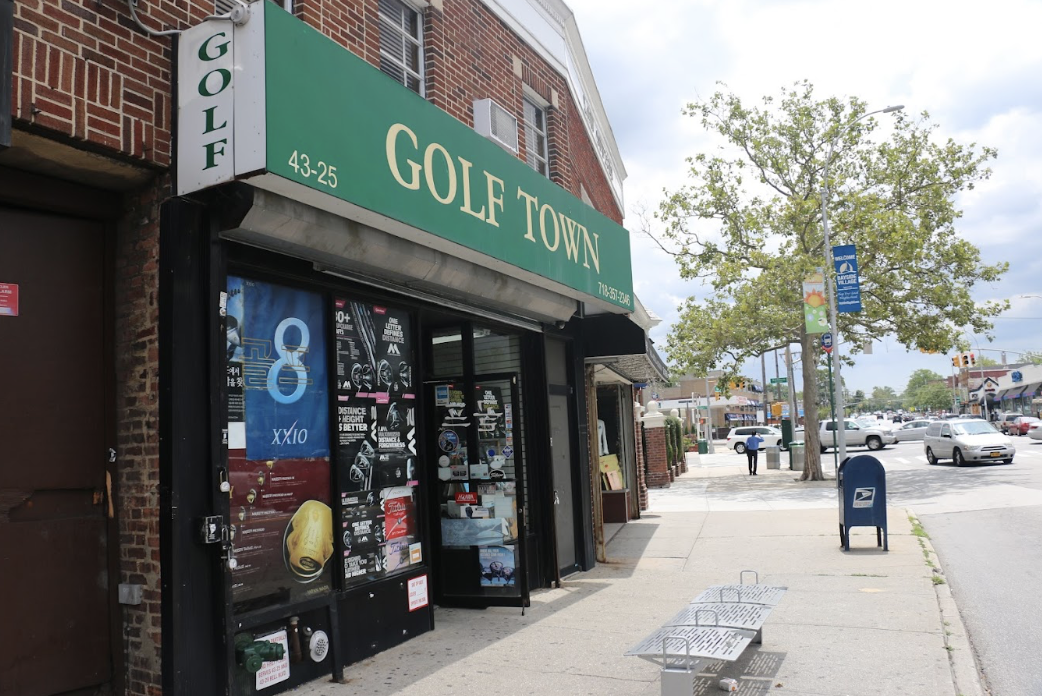 A side-street view of the exterior of Golf Town on a mostly cloudy day in summer.