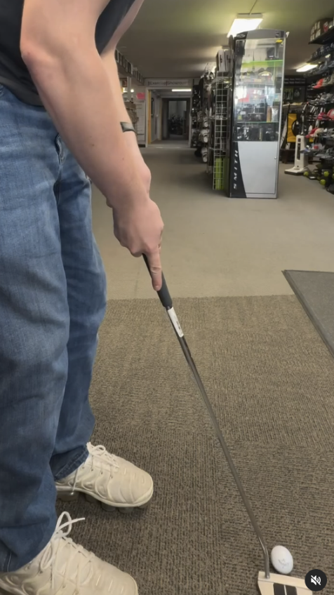 trying out used golf clubs in Play It Again Sports Portland