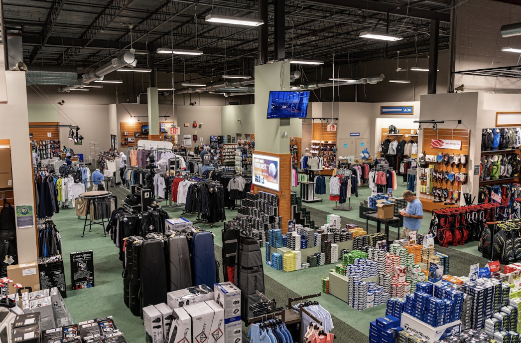 The inventory floor of Golfer's Warehouse featuring neatly stacked balls, apparel, clubs, and more.