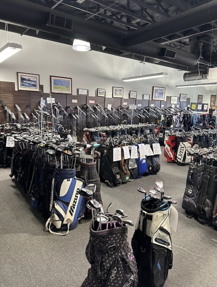 The interior of Golf Alley. The store floor contains a multitude of golf bags with cubs inside available to purchase/rent.