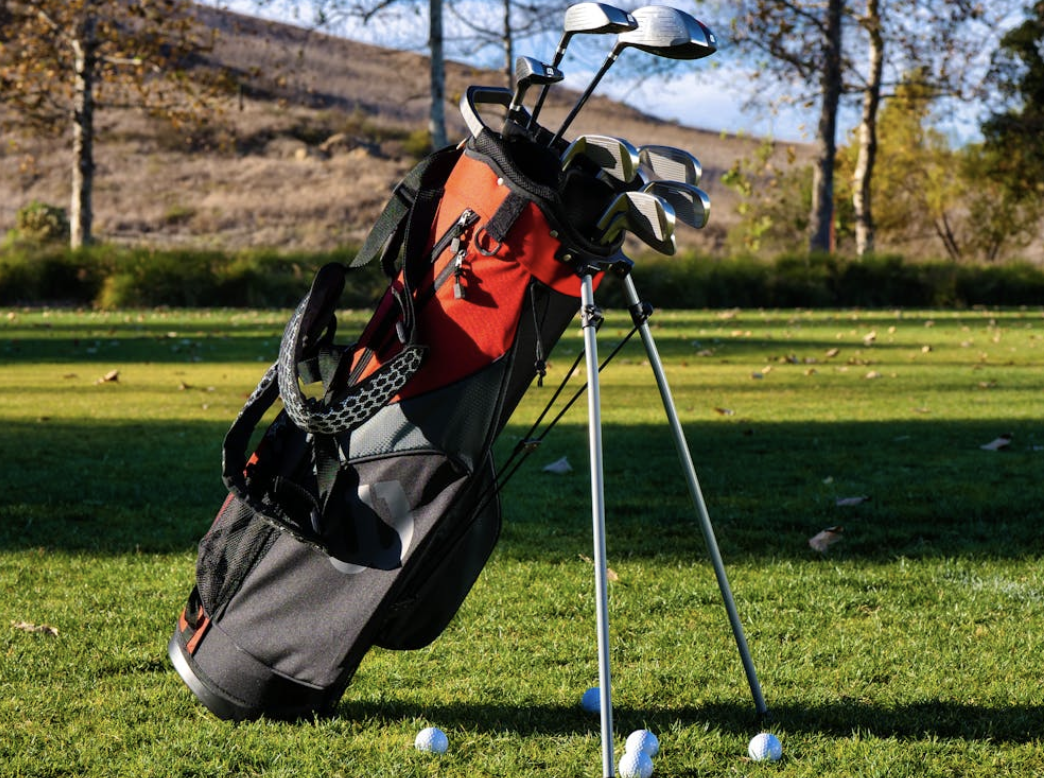 golf bag propped up on the green
