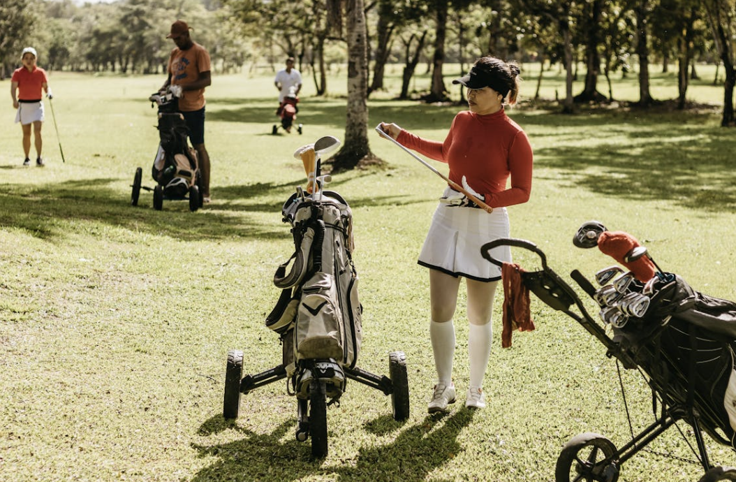 woman selecting a golf club from the bag